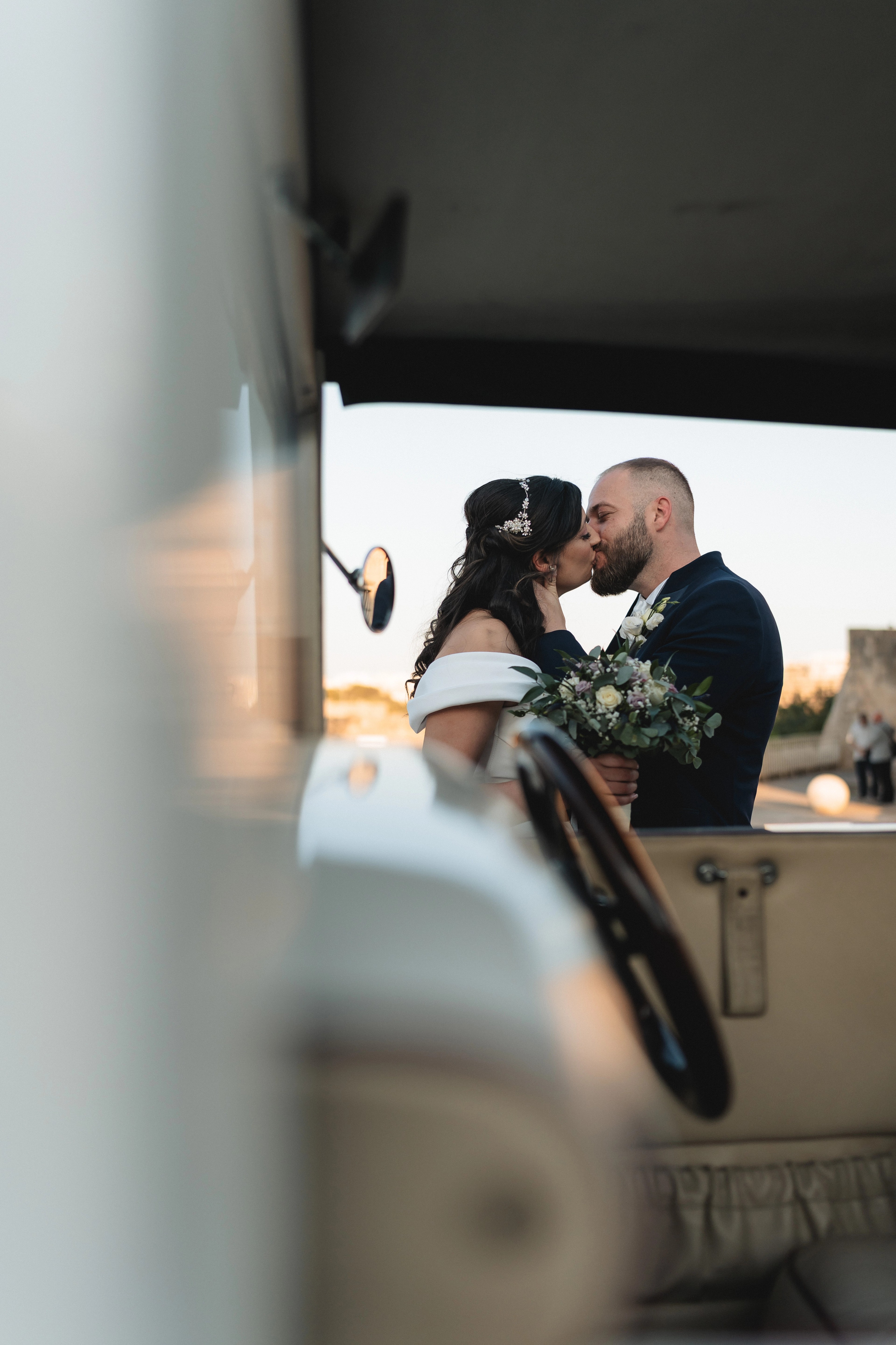 Bride and groom sharing a kiss during wedding portraits after their church ceremony at Misraħ tal-Maqluba in Malta, photographed by Malta wedding photographer Justin Galea.