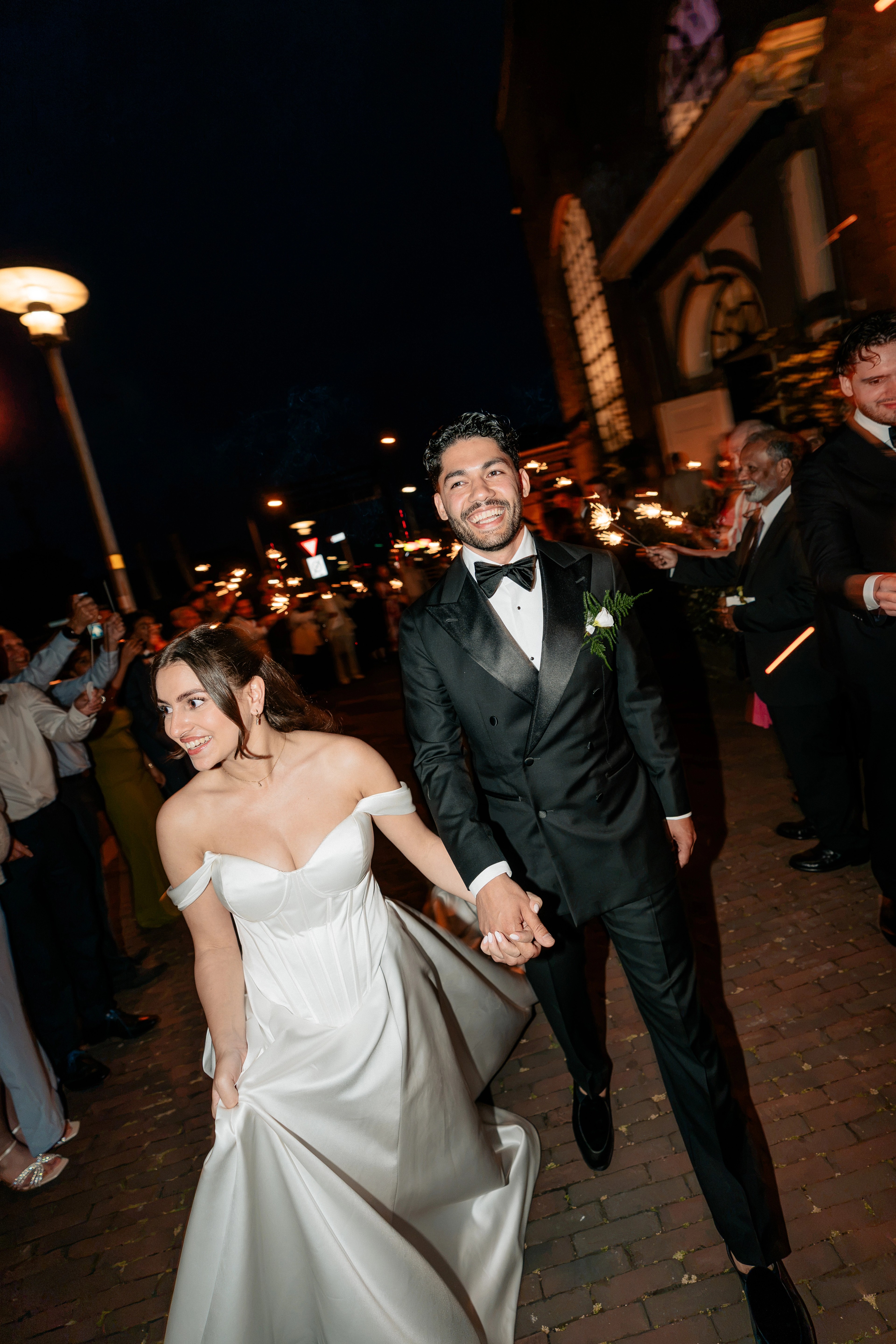 Bride and groom walking through a sparkler send-off after their destination wedding in Den Helder, Netherlands, photographed by Malta destination wedding photographer Justin Galea.