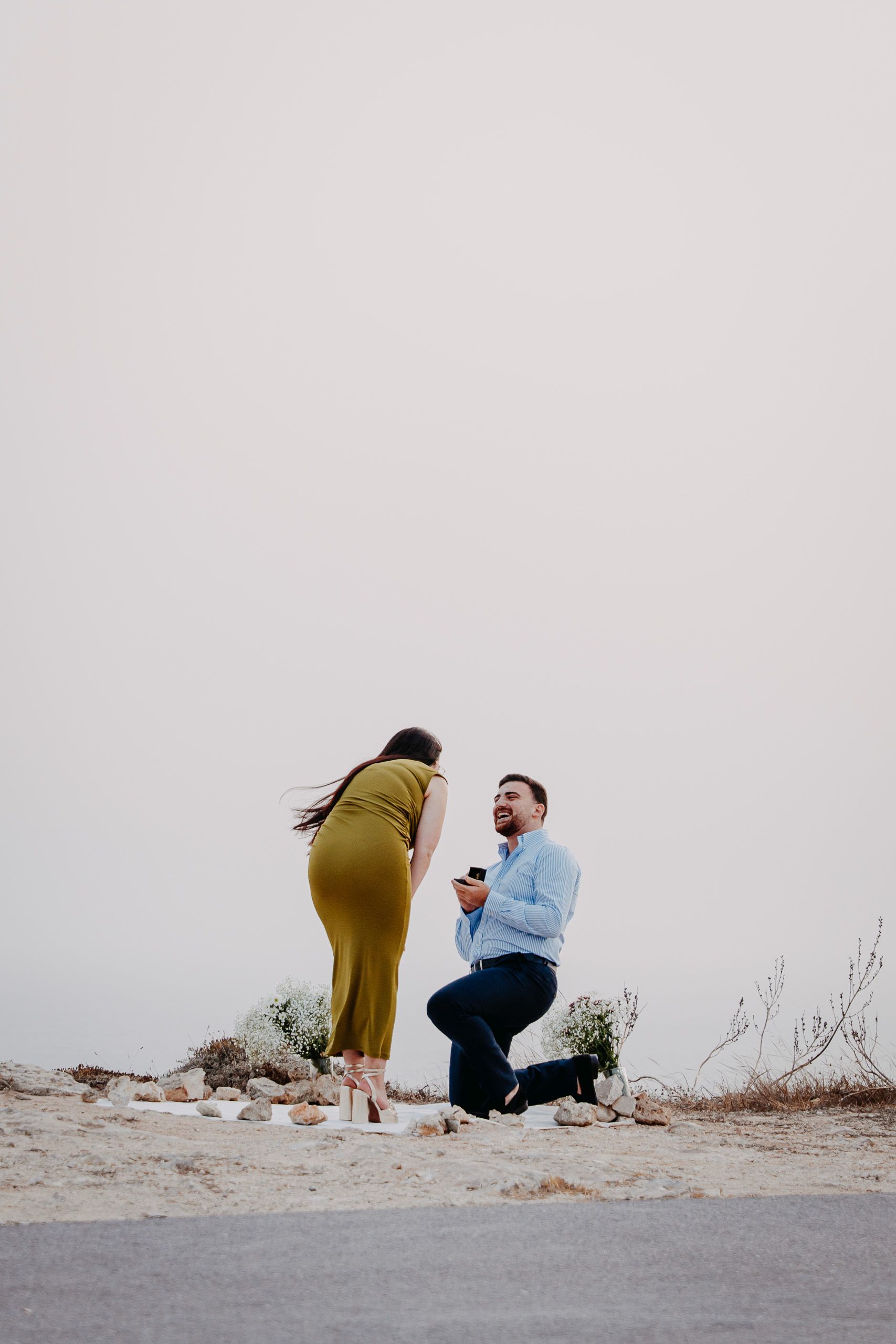 Surprise marriage proposal at Dingli Cliffs, Malta with man down on one knee