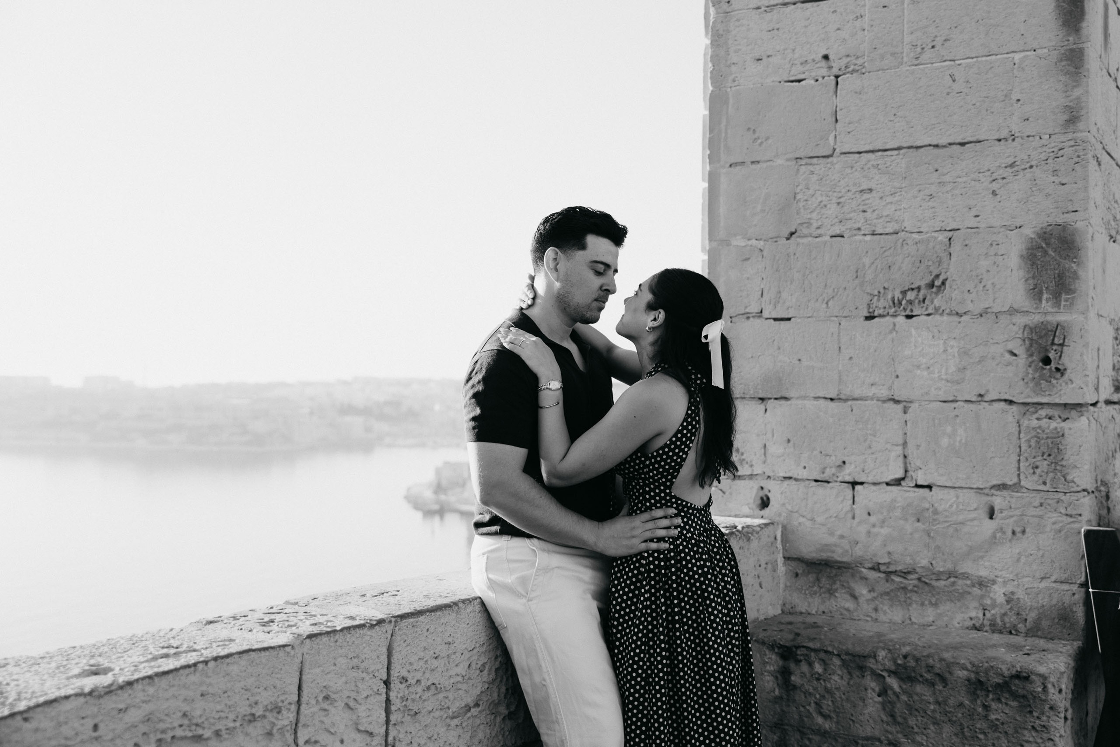 Couple portrait at Upper Barrakka Gardens in Valletta, Malta, overlooking the Grand Harbour after their proposal.