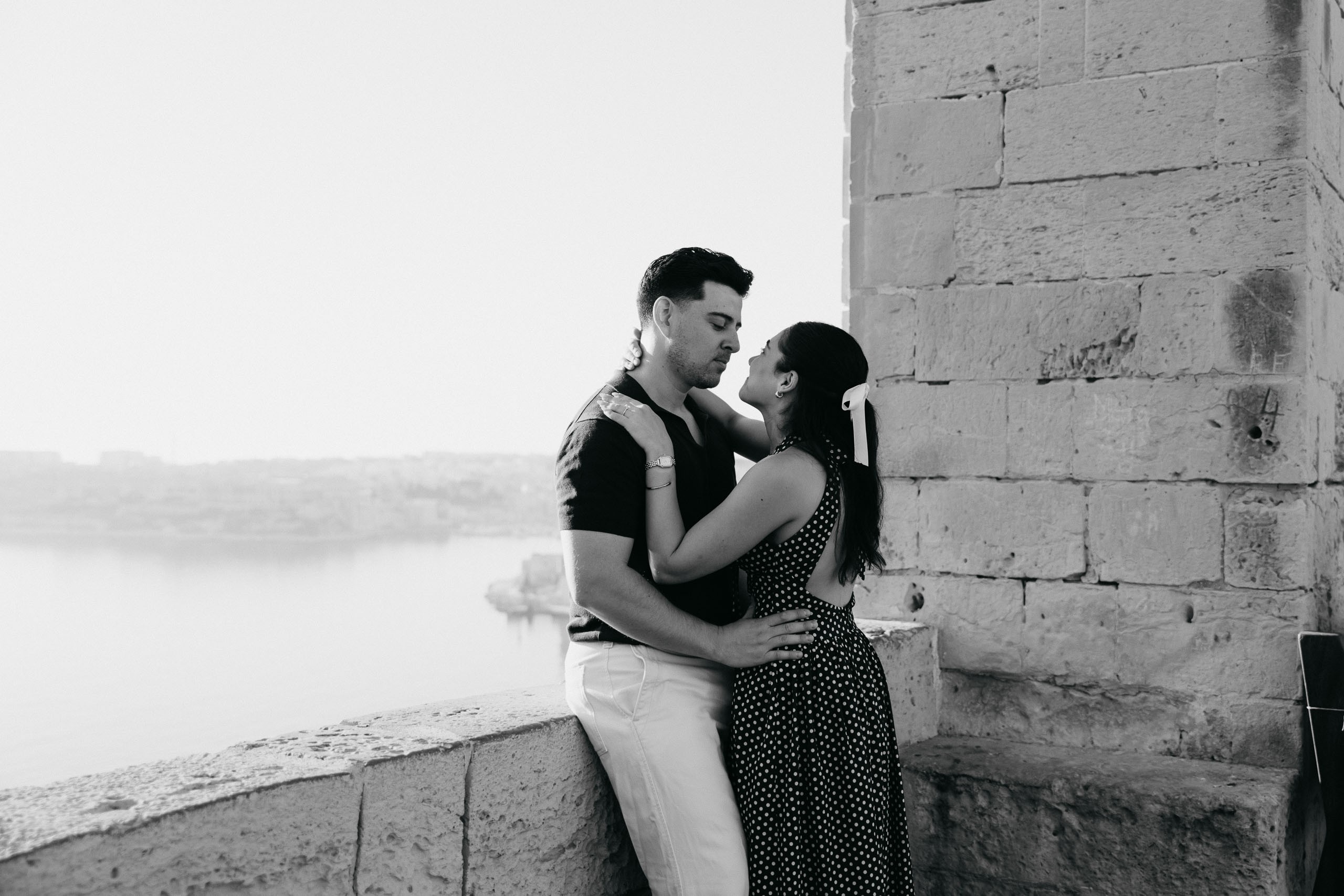 Couple portrait at Upper Barrakka Gardens in Valletta, Malta, overlooking the Grand Harbour after their proposal.