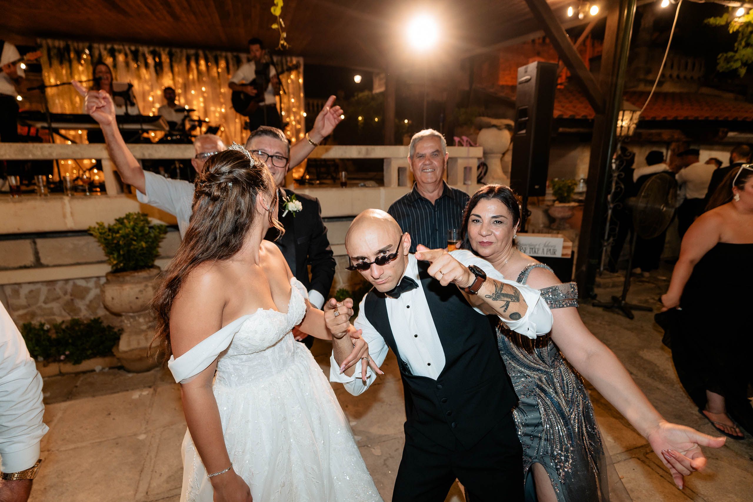 Bride dancing with wedding guests during the evening reception at Ir-Razzett L-Abjad in Malta.