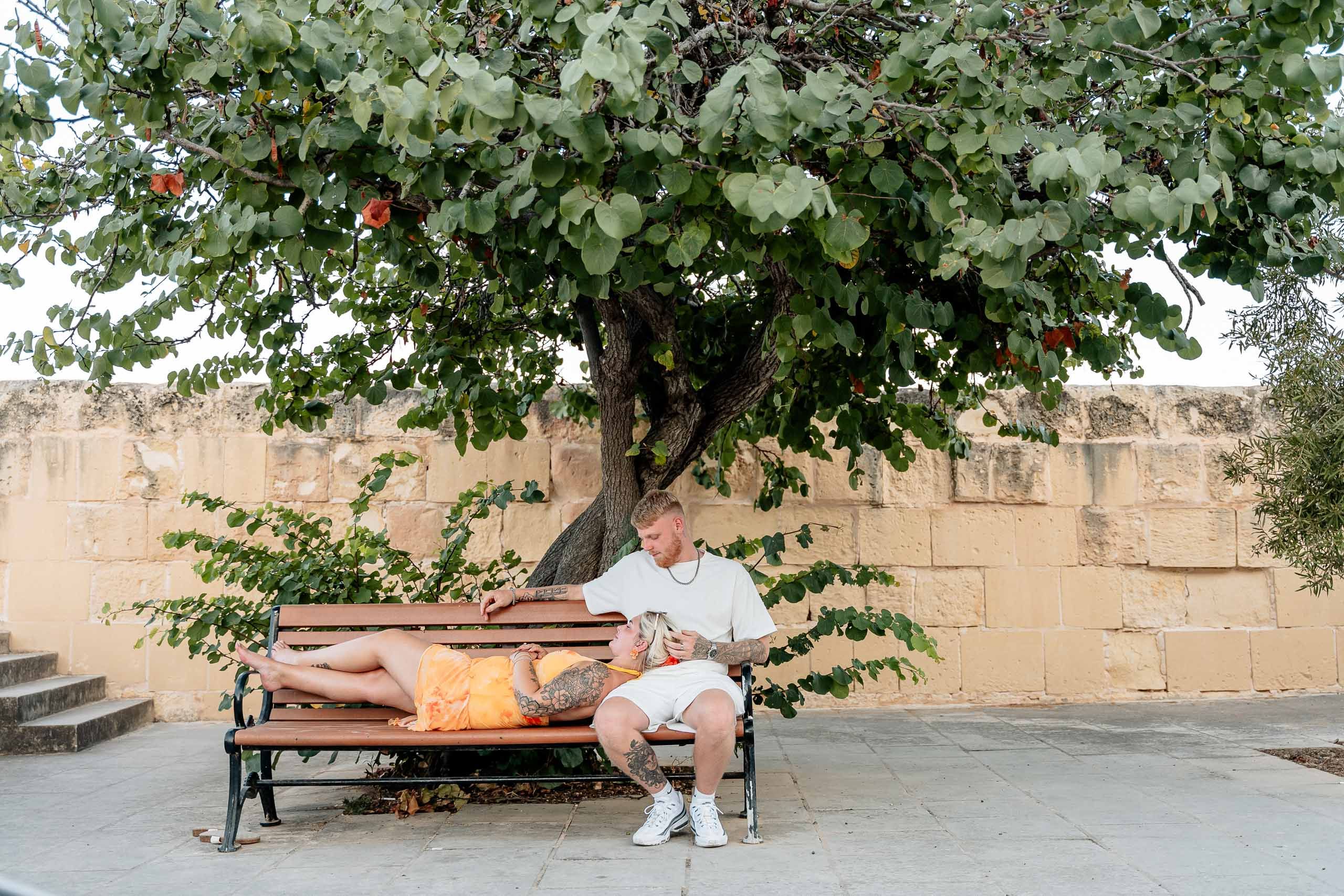Engaged couple relaxing during a proposal photoshoot in Birgu, Malta