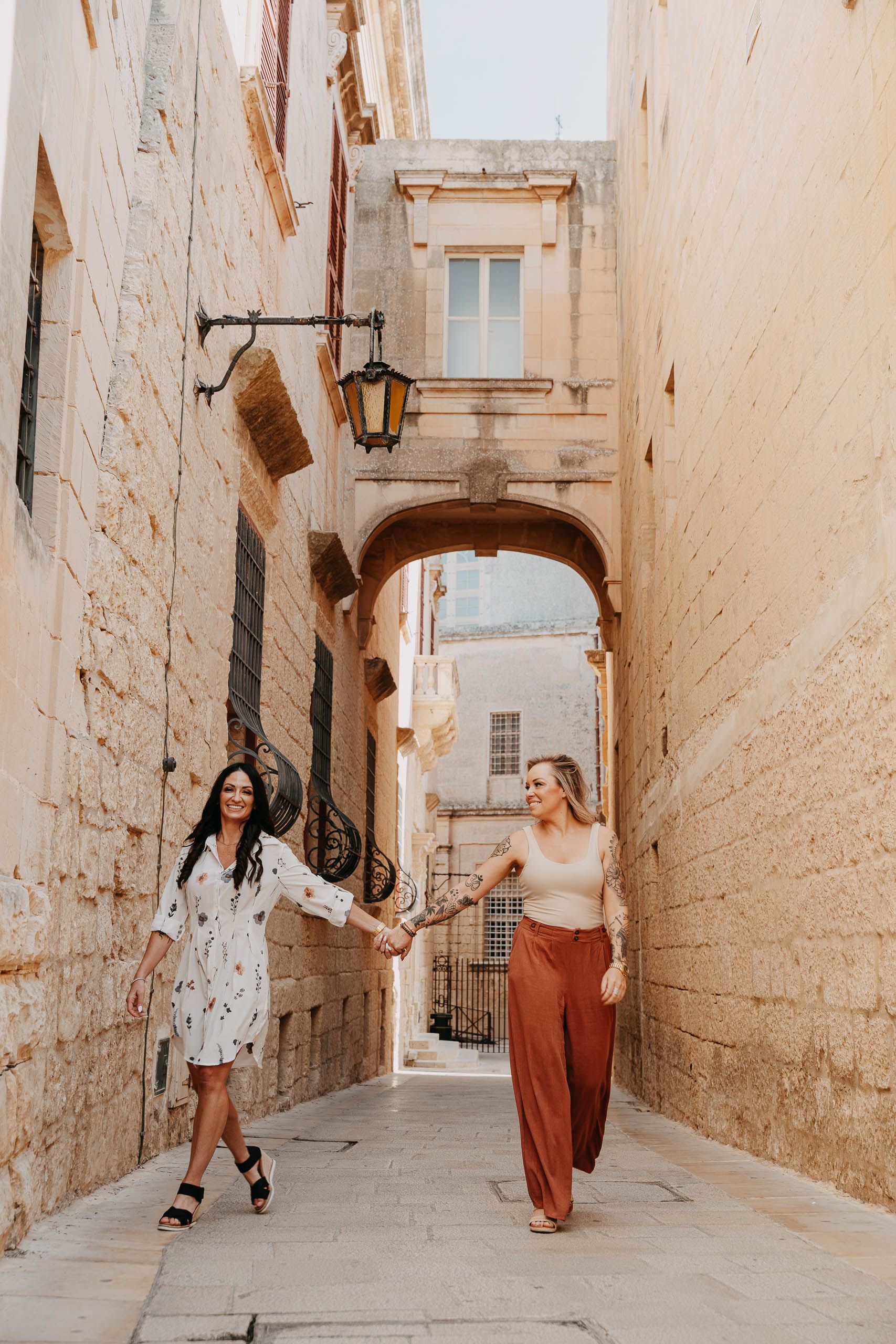Newly engaged couple holding hands in the historic streets of Mdina, MaltaNewly engaged couple holding hands in the historic streets of Mdina, Malta