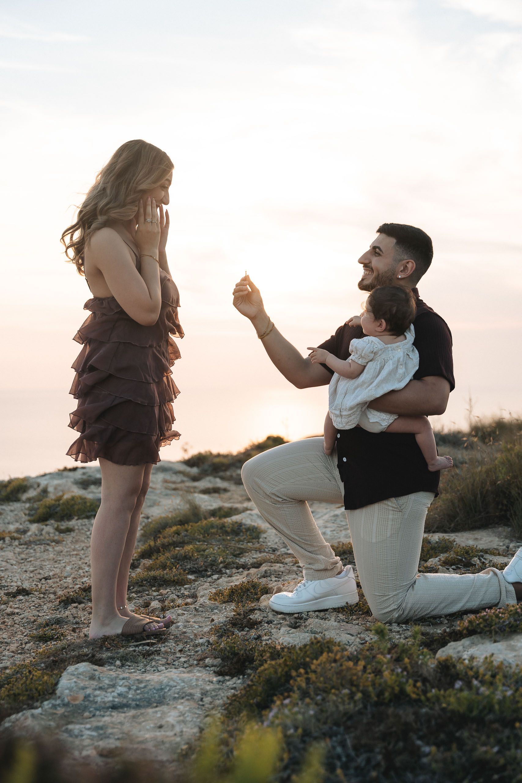 Surprise marriage proposal with couple and baby at Dingli Cliffs, Malta