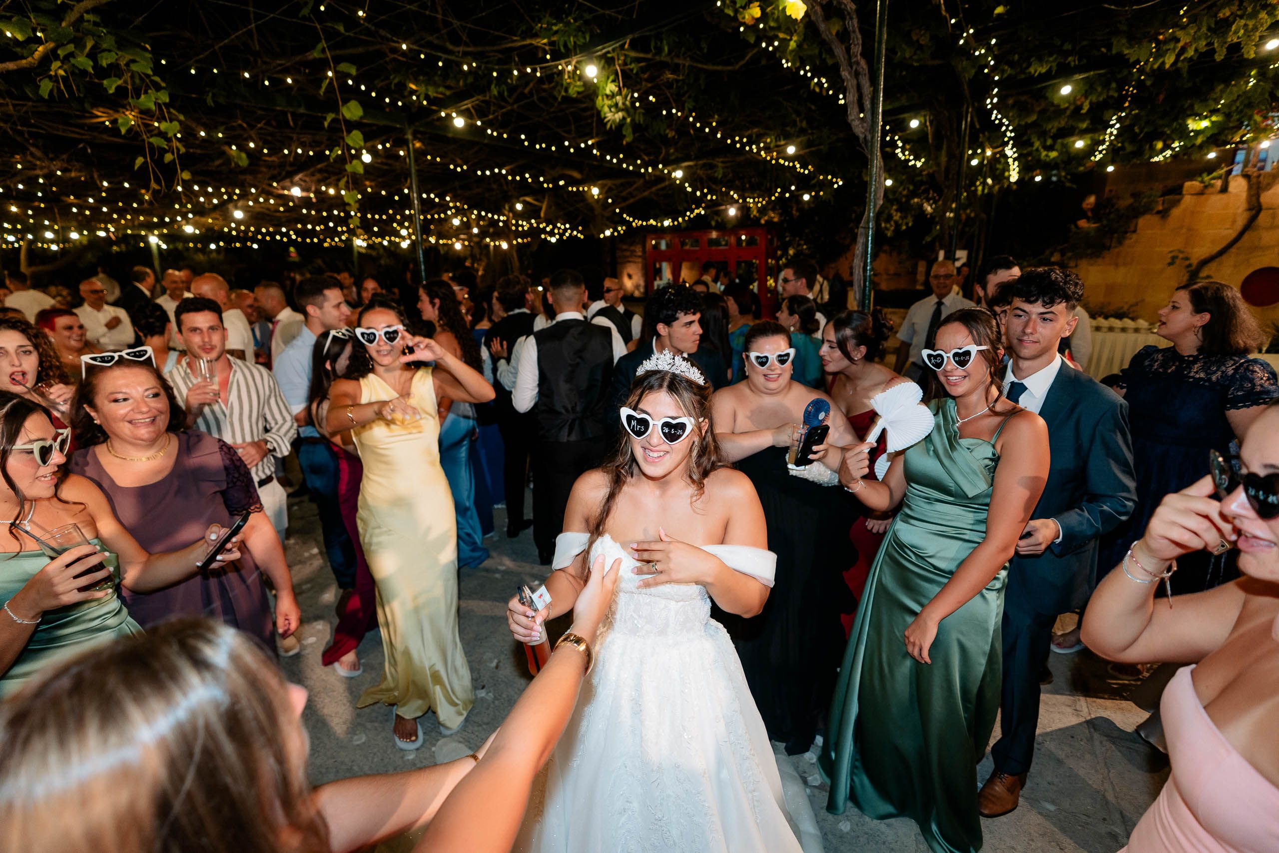 Bride celebrating on the dance floor with wedding guests at Ir-Razzett L-Abjad in Malta.