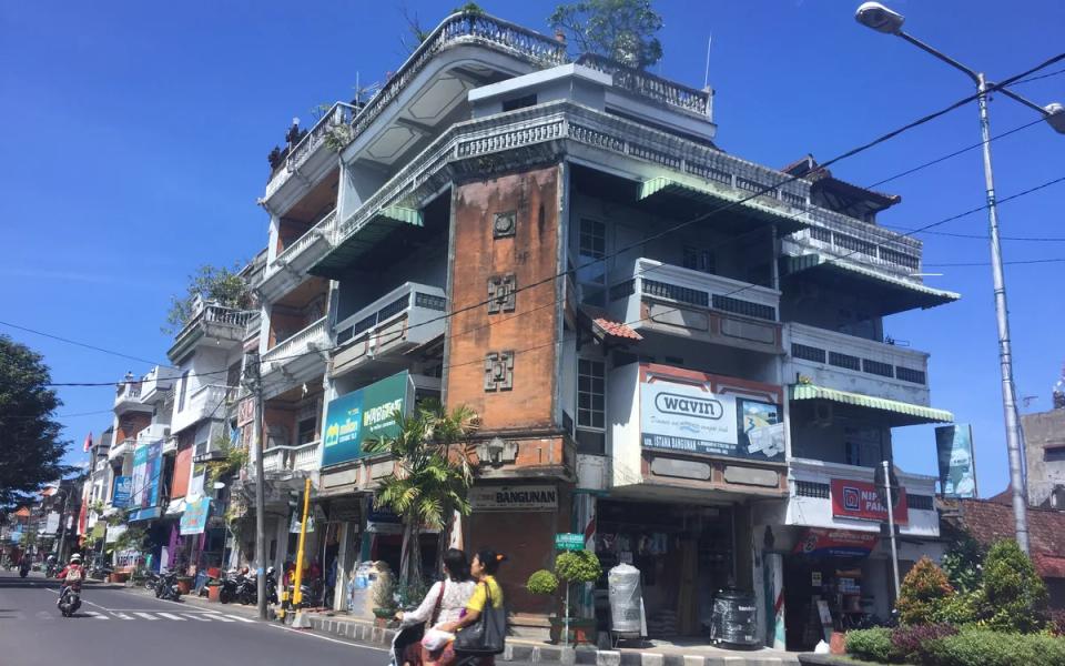 Shopfronts and motorcycles along a street in Klungkung, Bali.