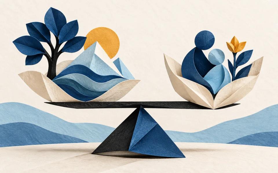 Folded paper shapes and a small cobalt balance arranged on warm paper.