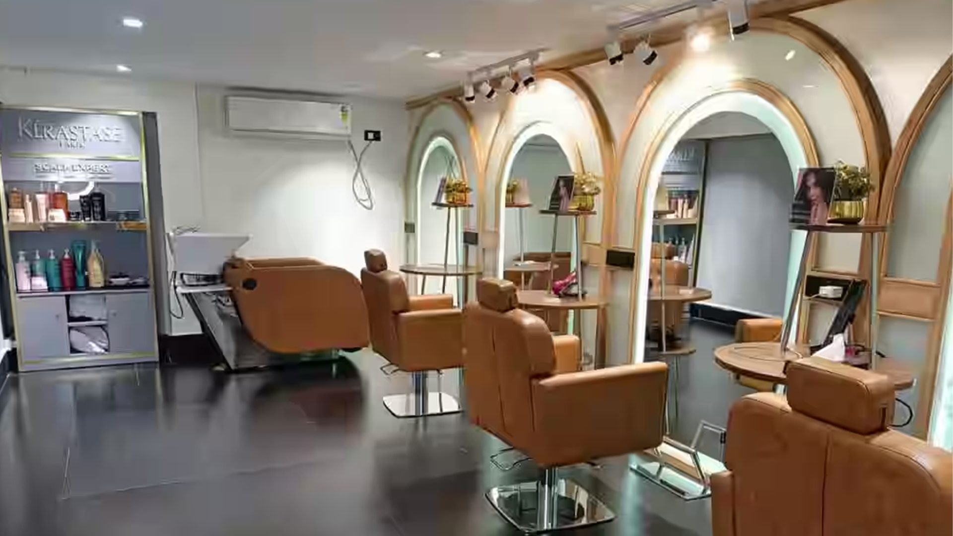 The Monsoon Salon floor in Kolkata — styling chairs beneath warm arched alcoves