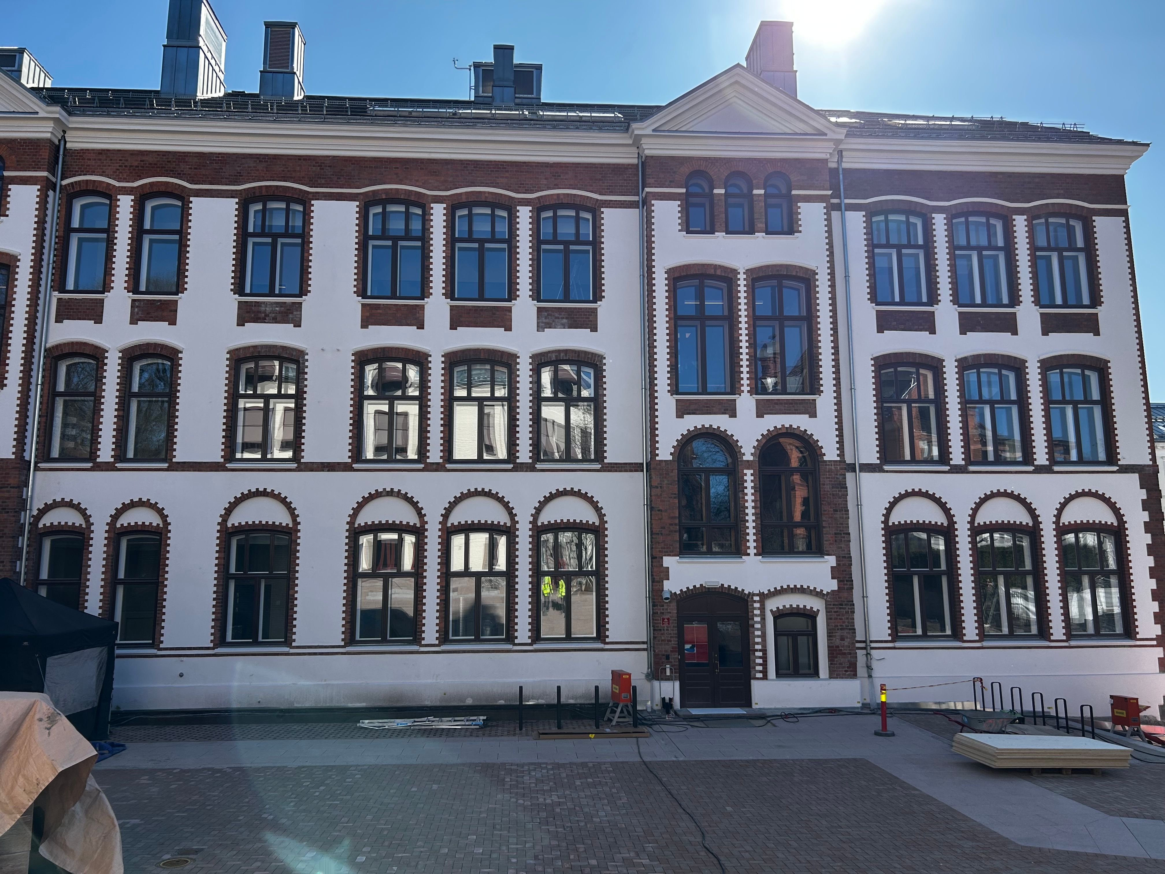 a large white building with a lot of windows on a sunny day .