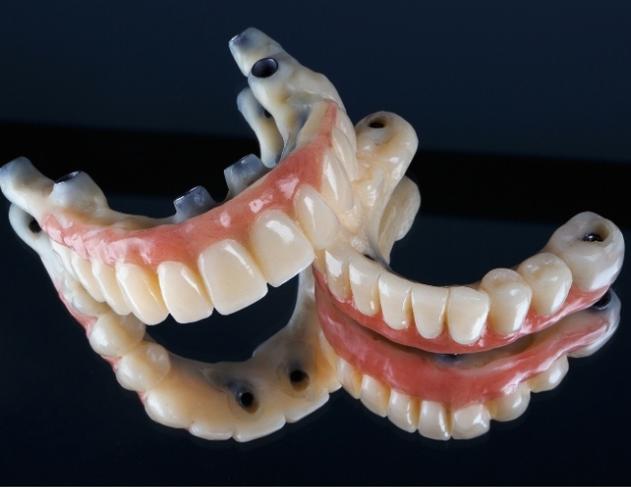 a close up of a pair of dentures on a black surface .