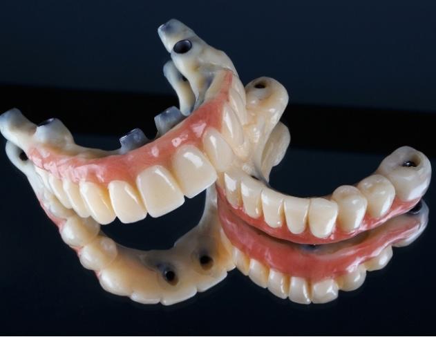 a close up of a pair of dentures on a black surface .