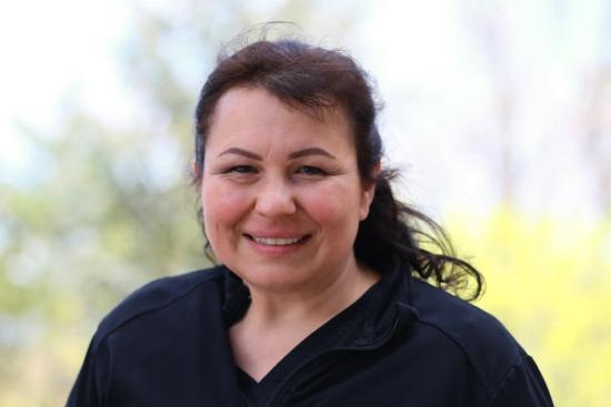 a woman in a black shirt is smiling for the camera .