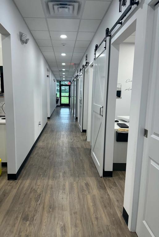 a long hallway in a dental office with sliding barn doors