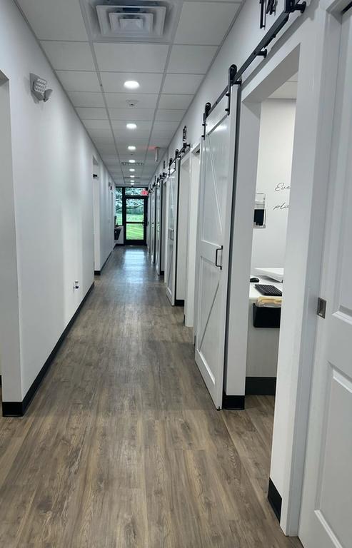 a long hallway in a dental office with sliding barn doors