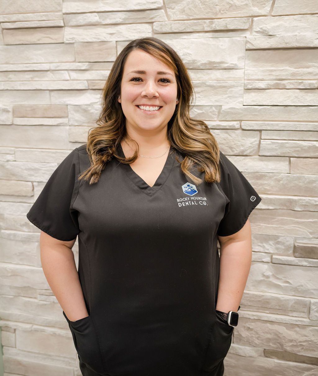 a woman wearing a black scrub top from rocky mountain dental co.