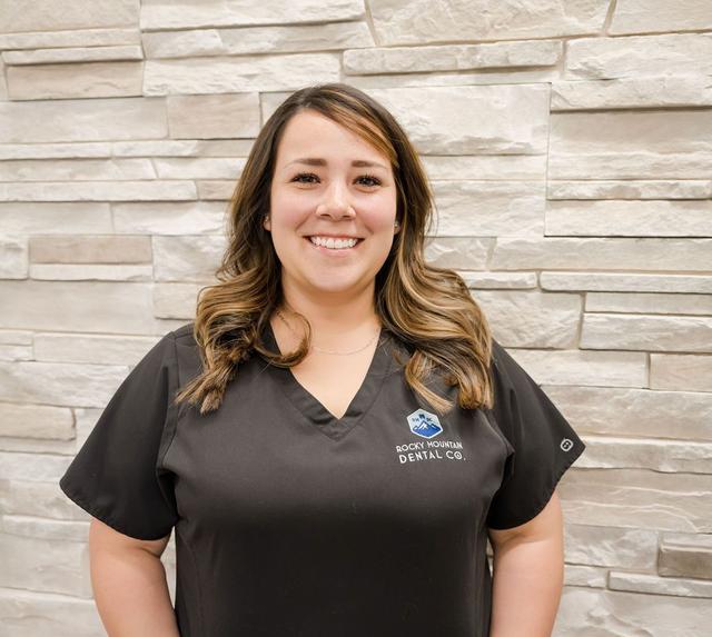 a woman wearing a black scrub top from rocky mountain dental co.
