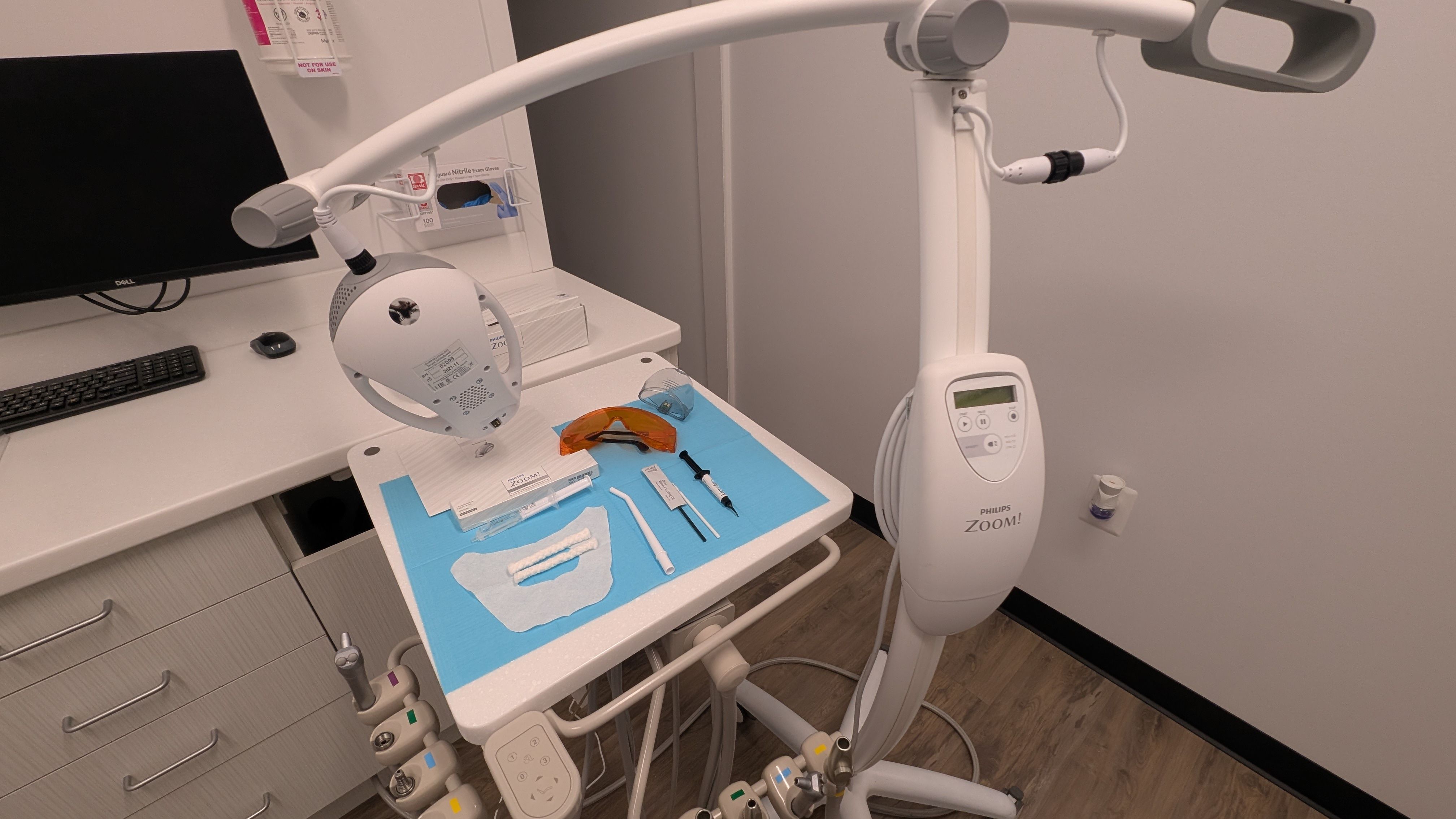 a dental office with a dental chair and a whitening machine .