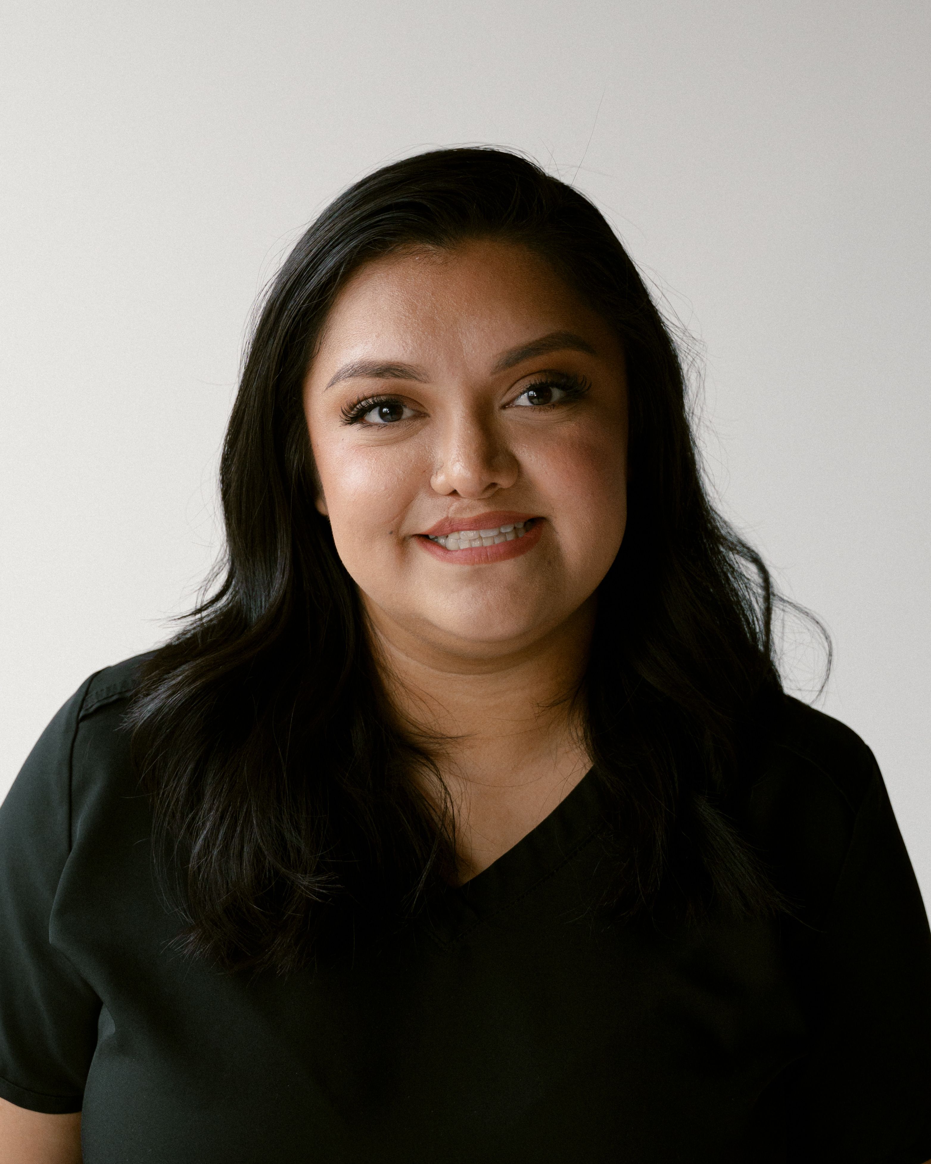 a woman with braces on her teeth smiles for the camera