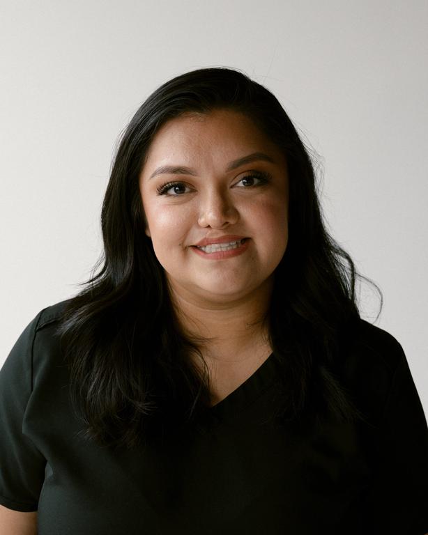 a woman with braces on her teeth smiles for the camera