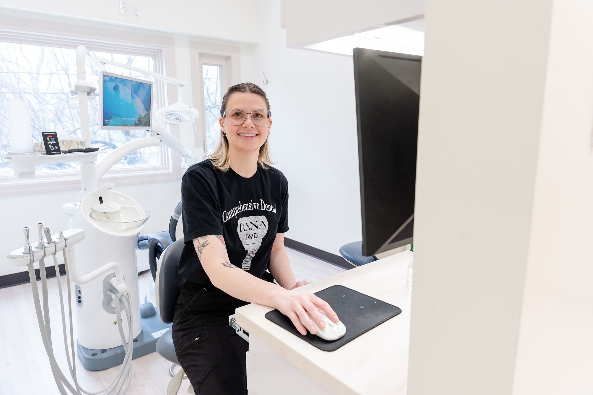 a woman is sitting at a desk in front of a computer .