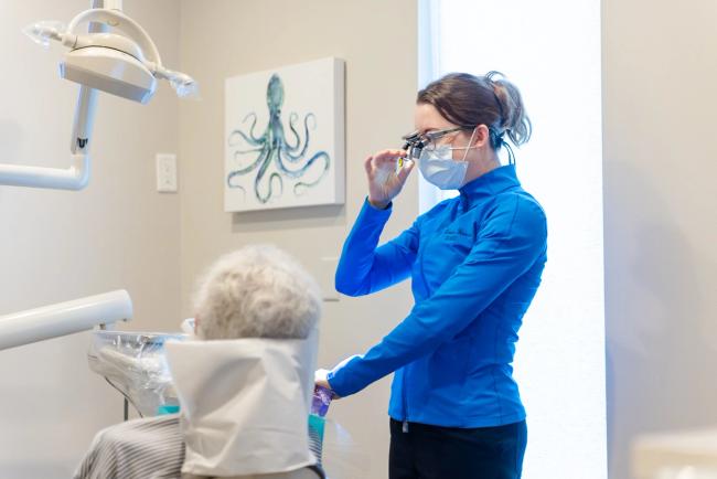 a man with a beard is putting a mouth guard on his teeth .