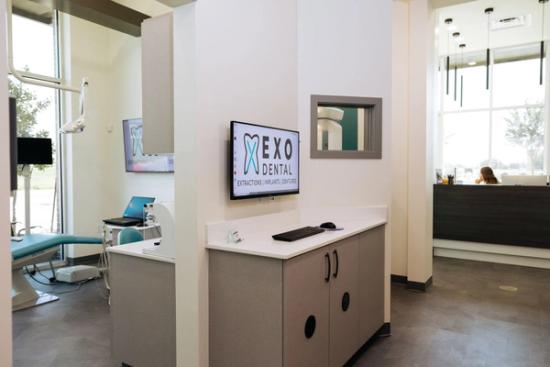 a dental office with a tv mounted on the wall .