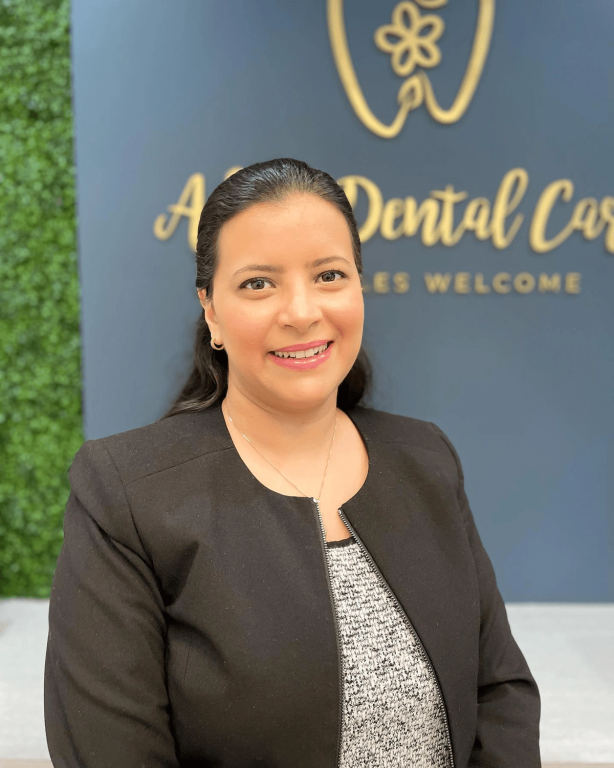 a woman stands in front of a sign that says a dental care