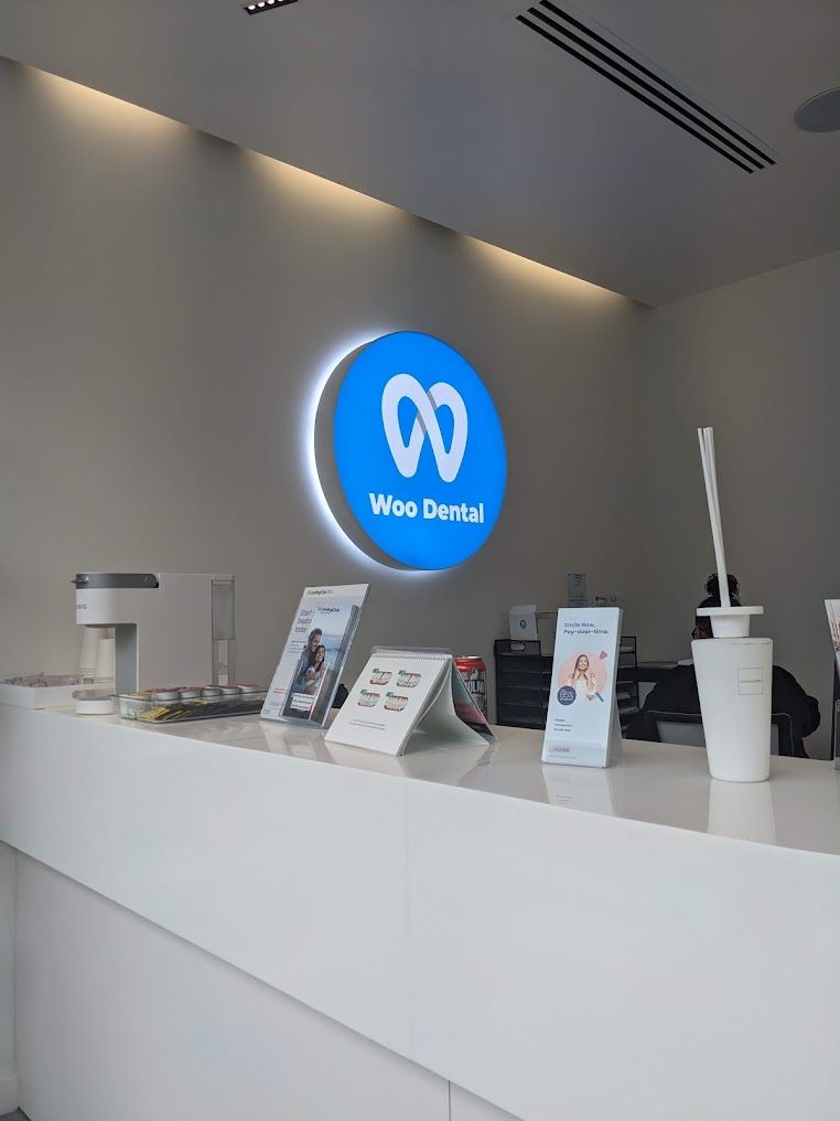 a blue sign that says woo dental on it