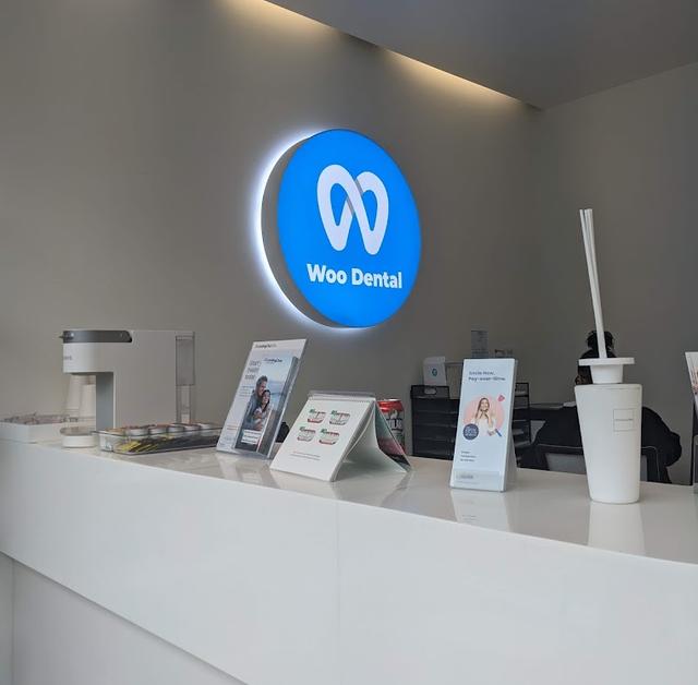 a blue sign that says woo dental on it