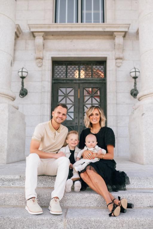 a family poses for a picture on the steps of a building