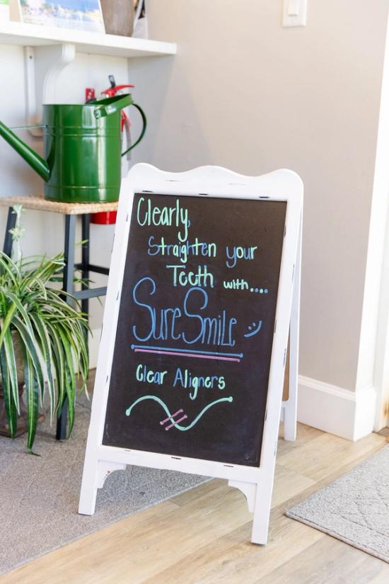 a sign that says clearly straighten your tooth with sure smile