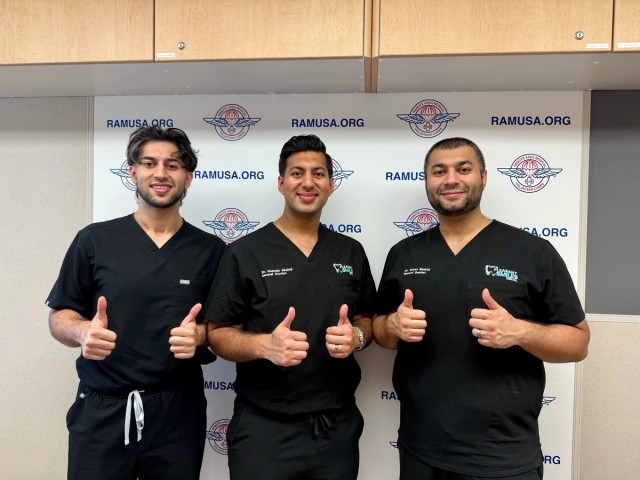 three men in scrubs are giving a thumbs up in front of a wall that says ramusa.org