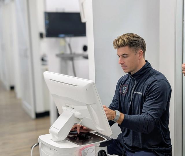a very cluttered office with two desks and two chairs .