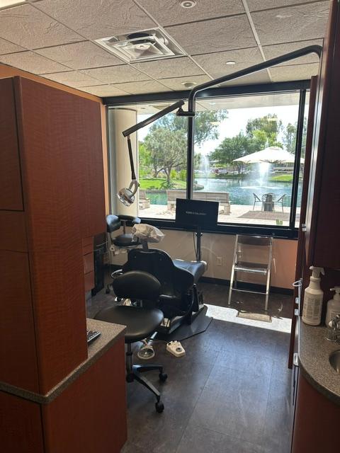 a dental office with a dental chair and a large window