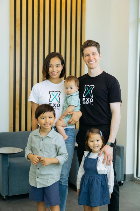 a family posing for a picture wearing exo dental shirts