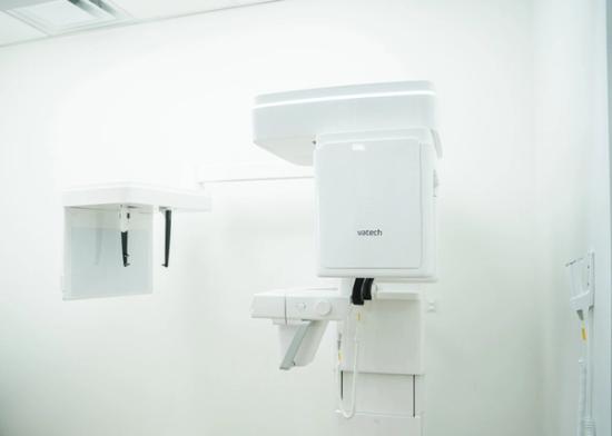 A Vatech dental imaging machine in a bright, white room.