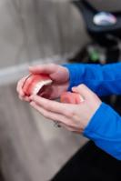 a close up of a smiling woman wearing a yellow and white striped shirt .