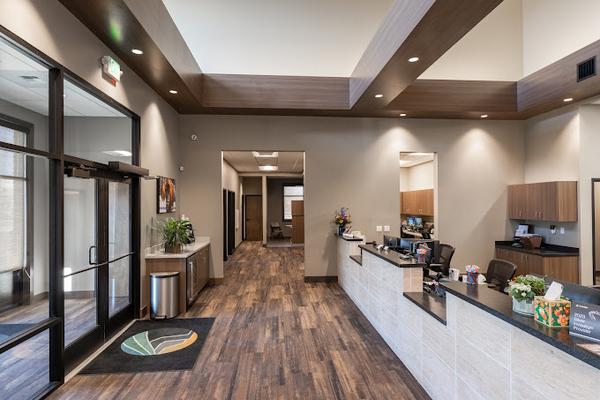a large lobby with a reception desk and a large window .