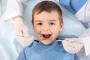 Happy boy with mouth open during a dental check-up.