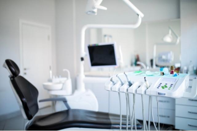a dental office with a dental chair and dental equipment .