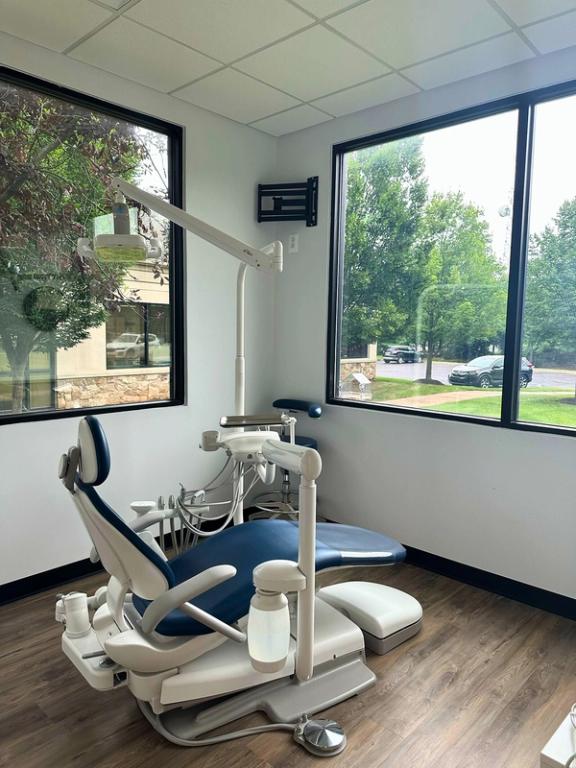 a dental office with a dental chair and a large window