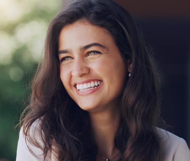 a close up of a woman smiling with her eyes closed .