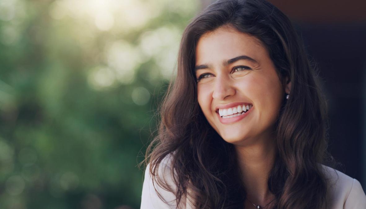 a close up of a woman smiling with her eyes closed .