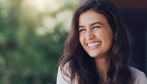a close up of a woman smiling with her eyes closed .
