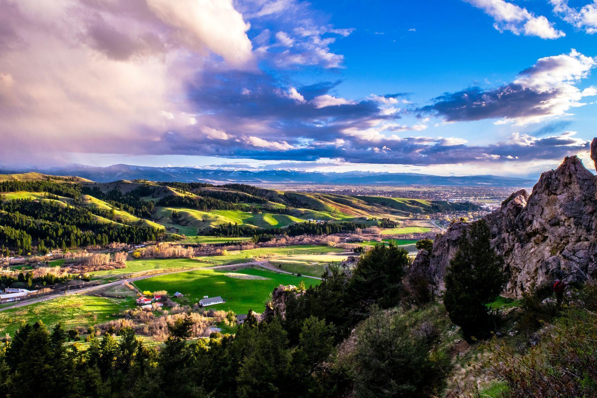 a view of a valley from the top of a mountain .