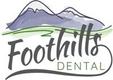 a logo for foothills dental with a mountain in the background .