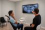Dr. G, at Rabbit Creek Dental, points to a dental X-ray on a screen for a patient with tooth pain in Mobile, AL.