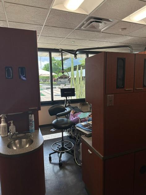 a woman is sitting at a desk in a waiting room .