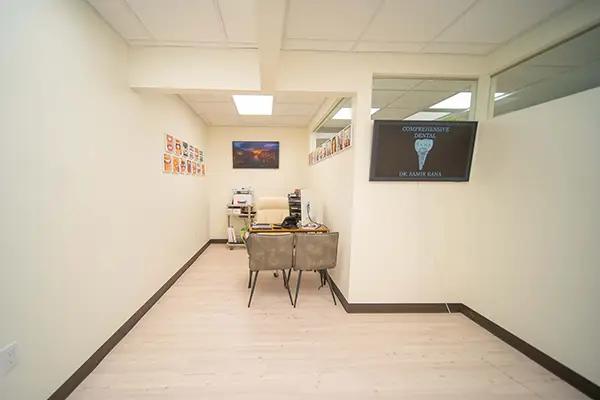 a small room with a desk and chairs in it .